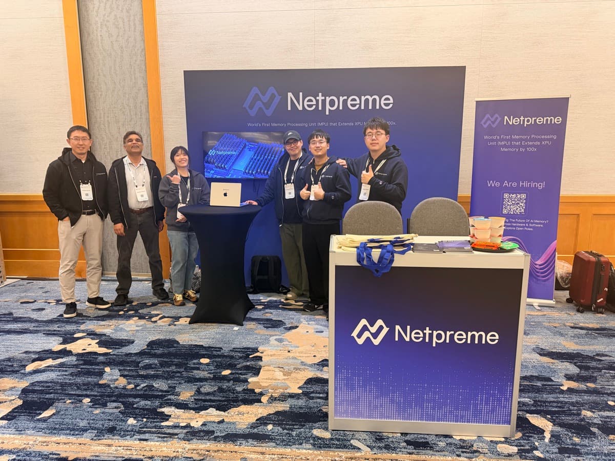 Six of the Netpreme team at their booth at MLSys 2026