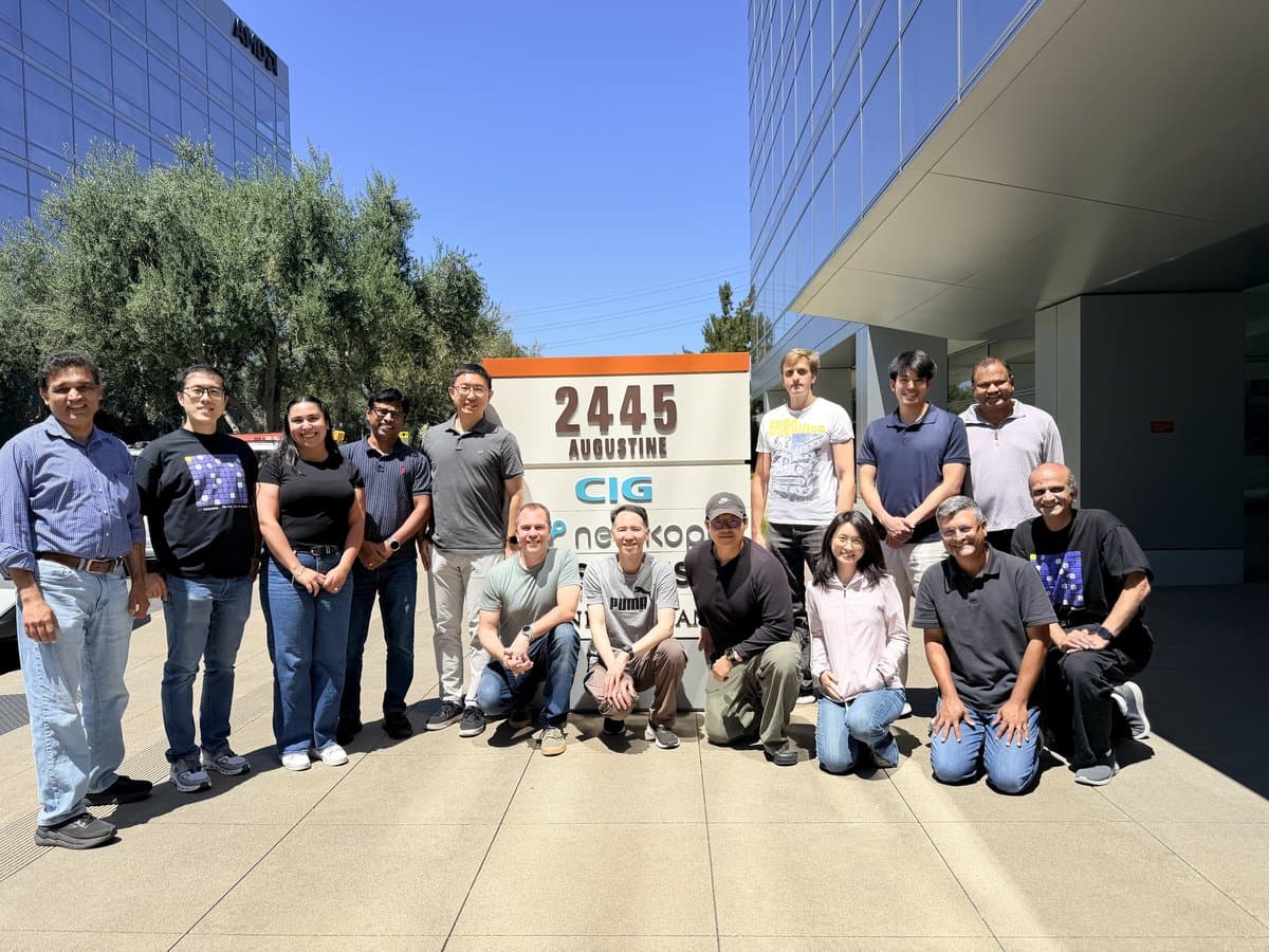 The Netpreme team gathered around the 2445 Augustine sign outside the Santa Clara office