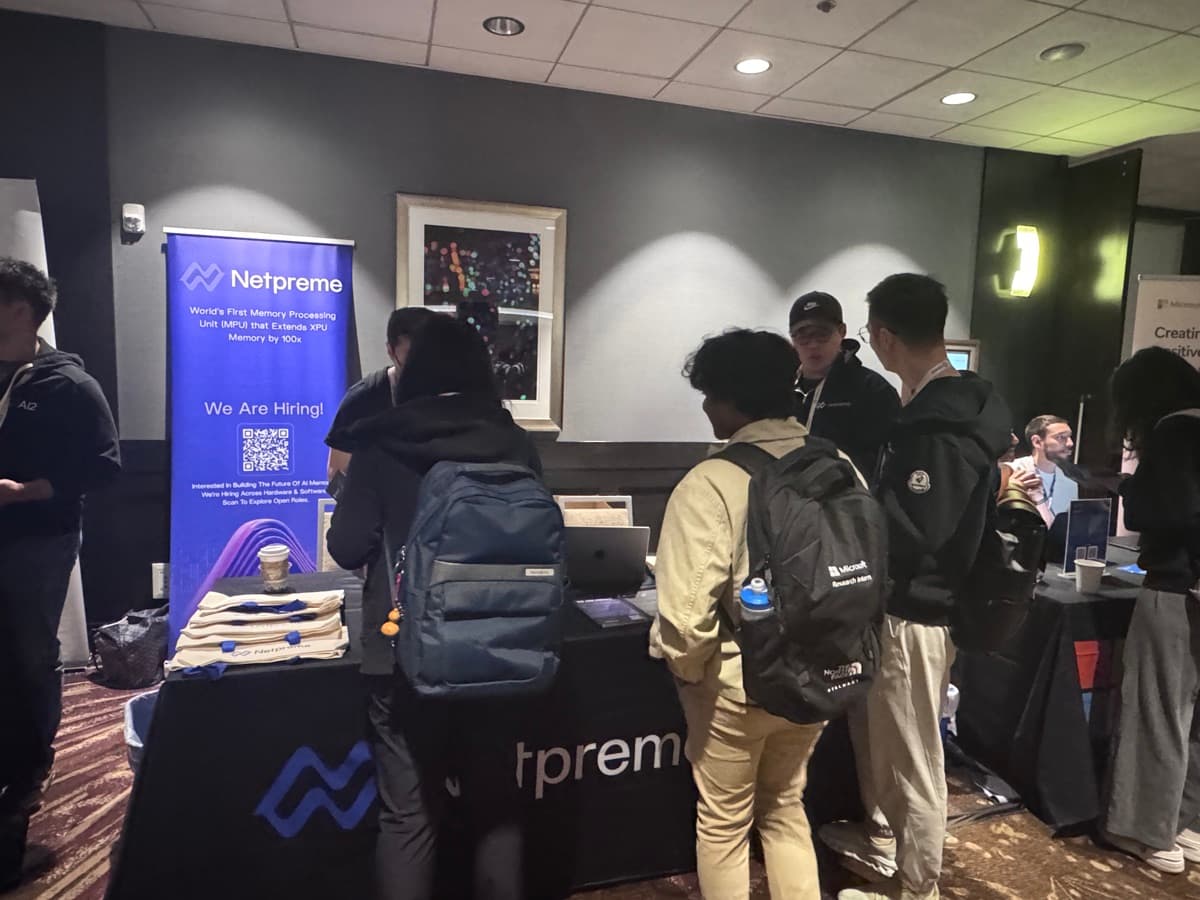 Students crowding the Netpreme recruiting booth beside a We Are Hiring banner