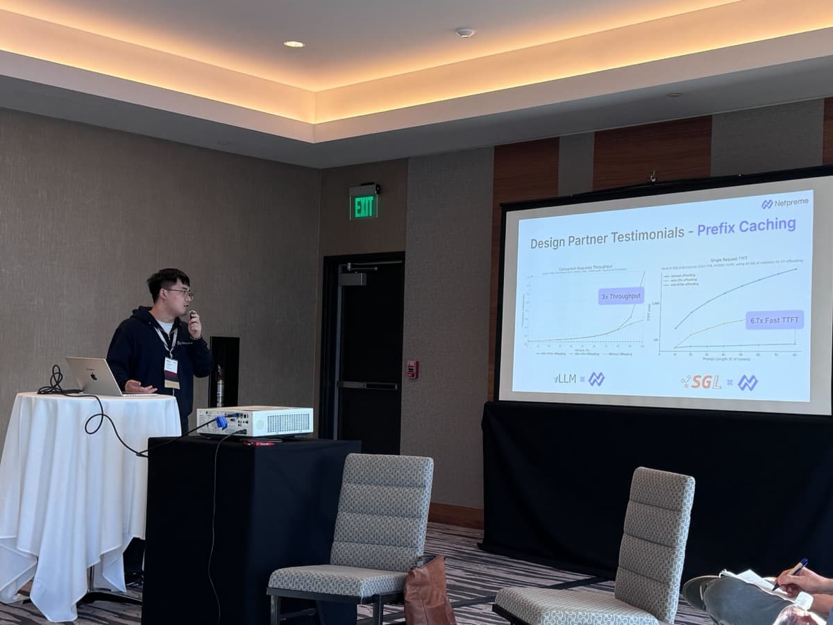 A Netpreme engineer presenting prefix-caching results to a conference room